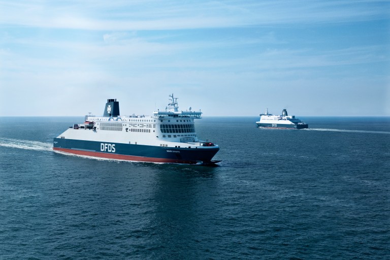 Two DFDS ferries cruise along a deep blue sea on a sunny dat