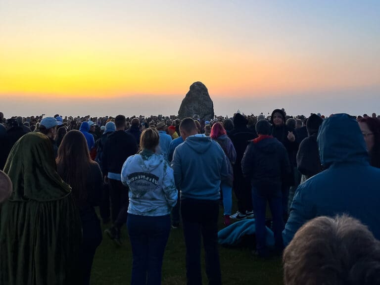 Summer Solstice at Stonehenge with a crowd at the site.