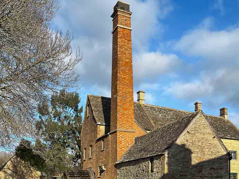 The Old Mill in the Cotswolds village, Bourton-on-the-Water. A Popular historical building to visit on a day tour to the Cotswolds from London.