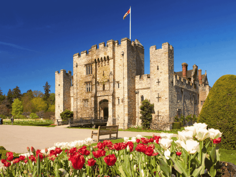 Hever Castle surrounded by its moat and gardens on a sunny day in Kent, visited on the Anderson Tours Leeds and Hever Castle Day Tour from London.