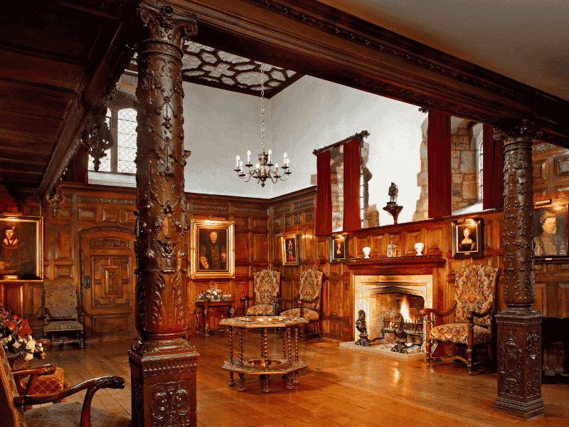 The Inner Hall of Hever Castle featuring Tudor wood panelling, portraits, and a grand fireplace — part of the Anderson Tours Leeds and Hever Castle Day Tour from London.