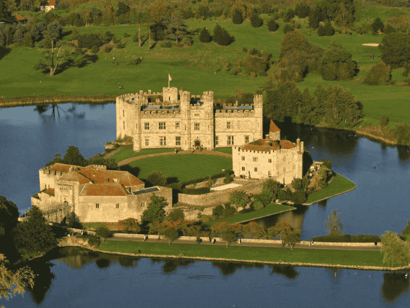 Aerial view of Leeds Castle surrounded by a lake and parkland in Kent — included on the Anderson Tours Leeds and Hever Castle Day Tour from London.