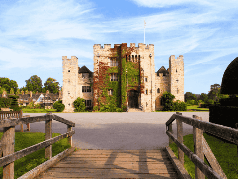 Hever Castle surrounded by its moat and gardens on a sunny day in Kent, visited on the Anderson Tours Leeds and Hever Castle Day Tour from London.